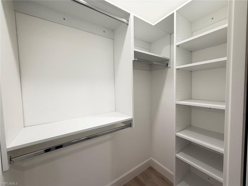 Walk in closet featuring light wood-style flooring