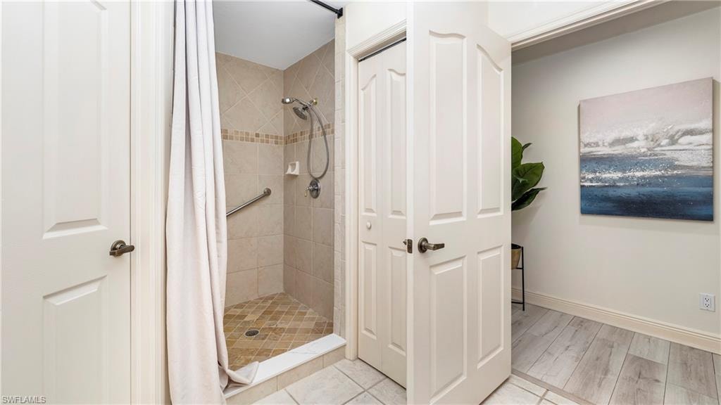 Bathroom with a stall shower and light wood-style flooring