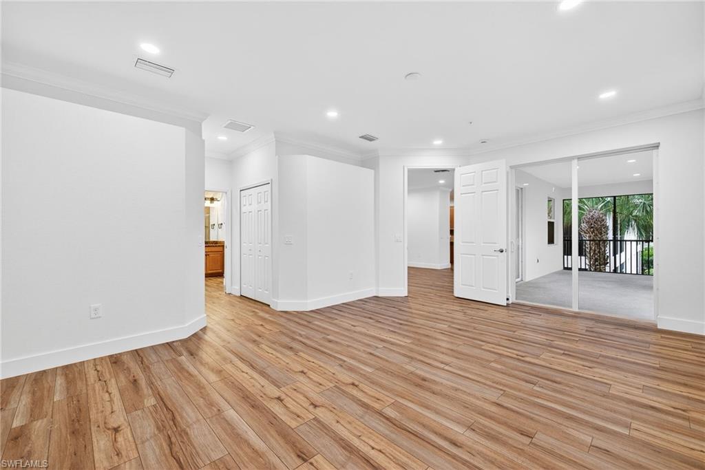 Unfurnished room with ornamental molding, light wood-style floors, and recessed lighting