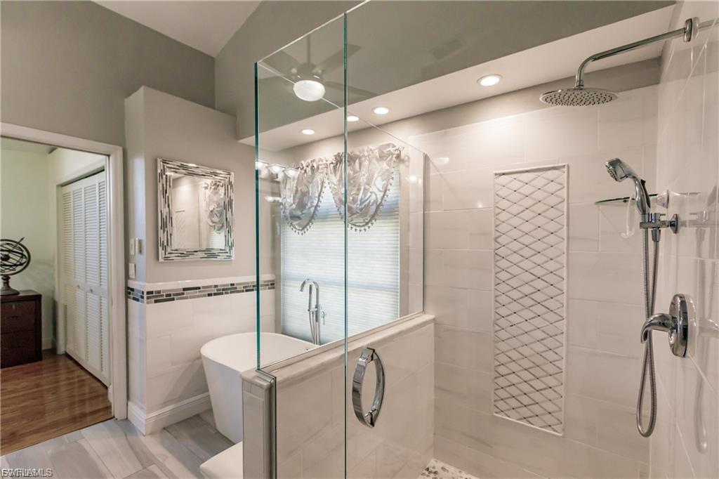 The Luxurious Primary En-Suite Bathroom retreat features both a Rainfall Shower and Elegant Soaker Tub to Calm Your Soul.