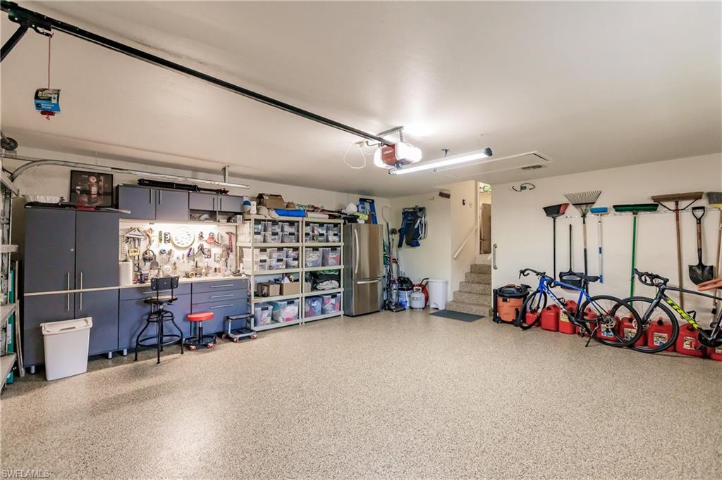 A Well organized Garage featuring a High Grade, Non-Skid Epoxy Floor with plenty of Natural Light
