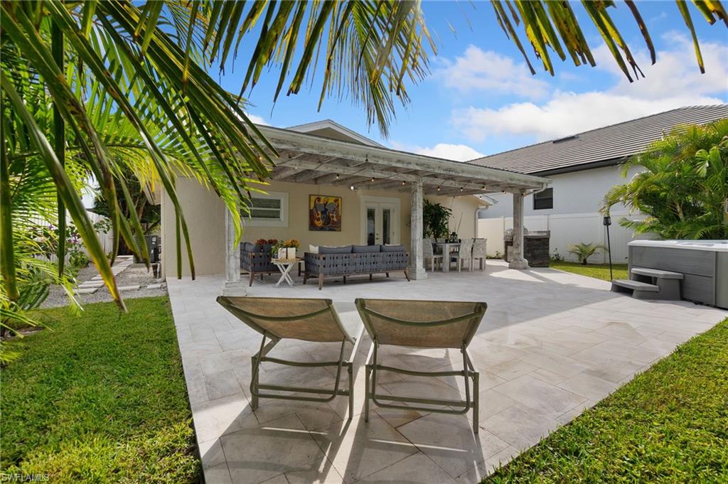 View of patio featuring an outdoor hangout area, a hot tub, french doors, and outdoor dining space