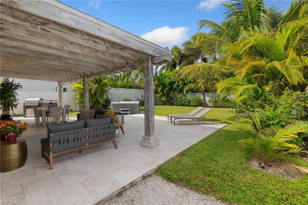Fenced backyard featuring an outdoor living space, a patio area, and outdoor dining area