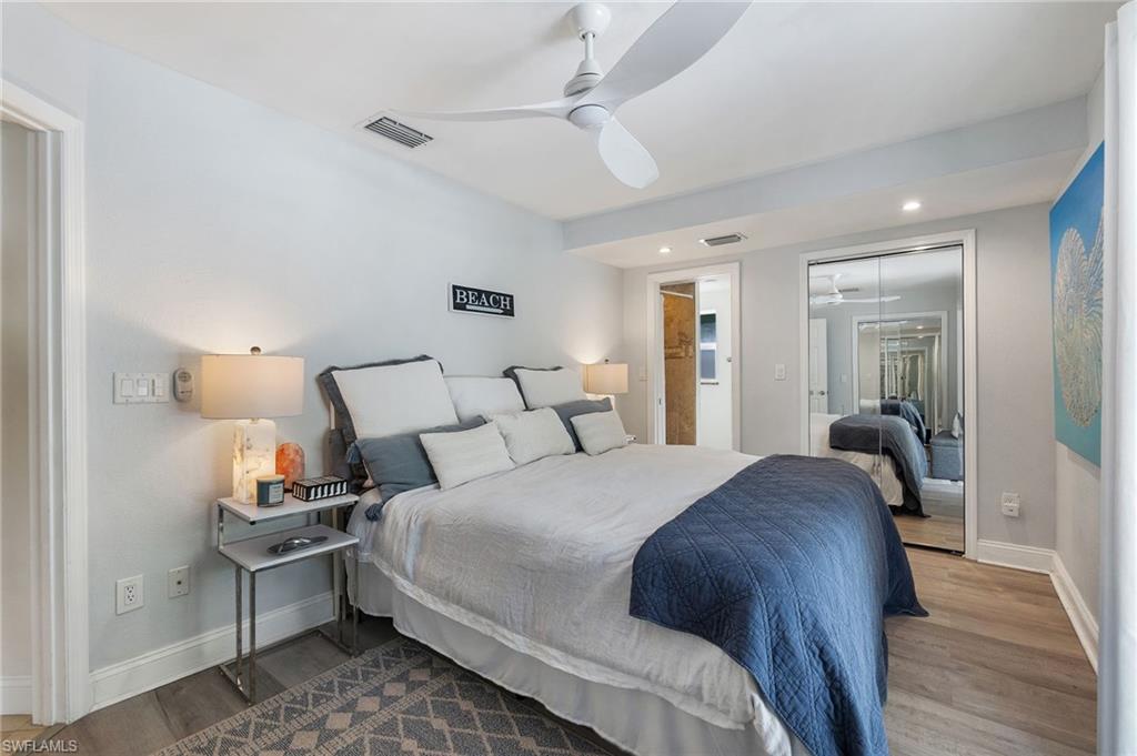 Bedroom with light wood-type flooring, a closet, recessed lighting, ceiling fan, and ensuite bathroom