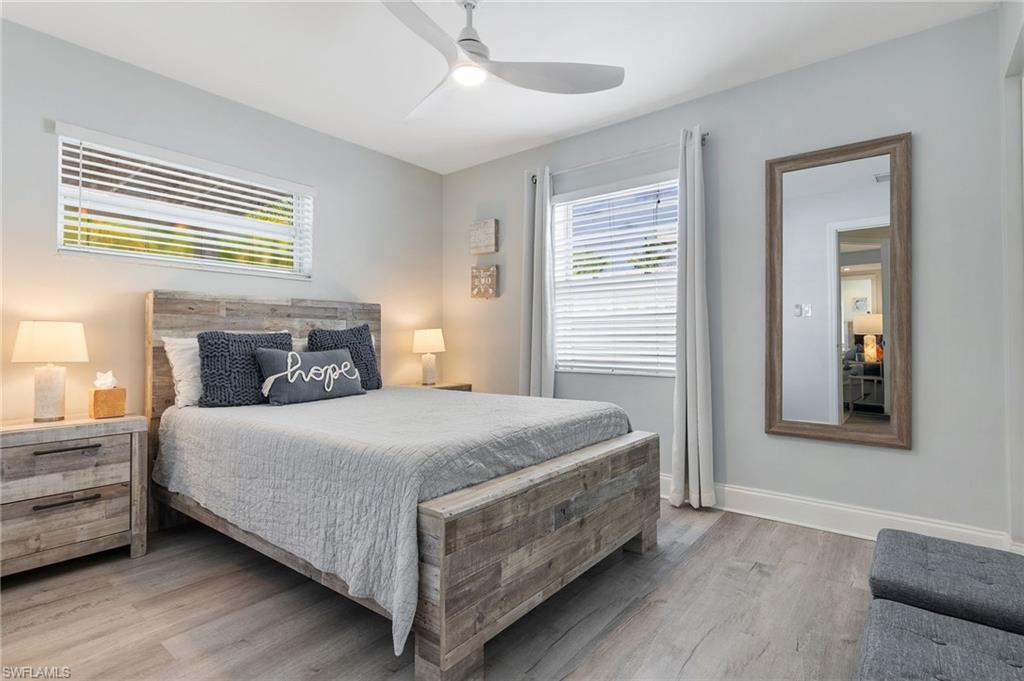 Bedroom with light wood-style floors and ceiling fan