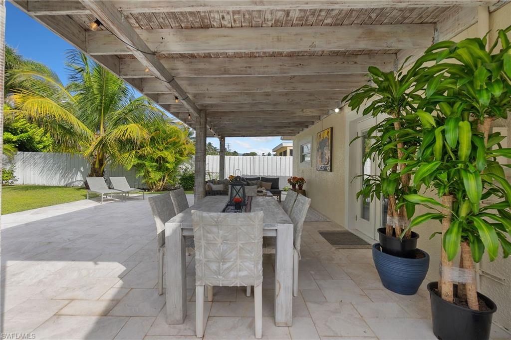 Fenced backyard with outdoor dining space and a patio area