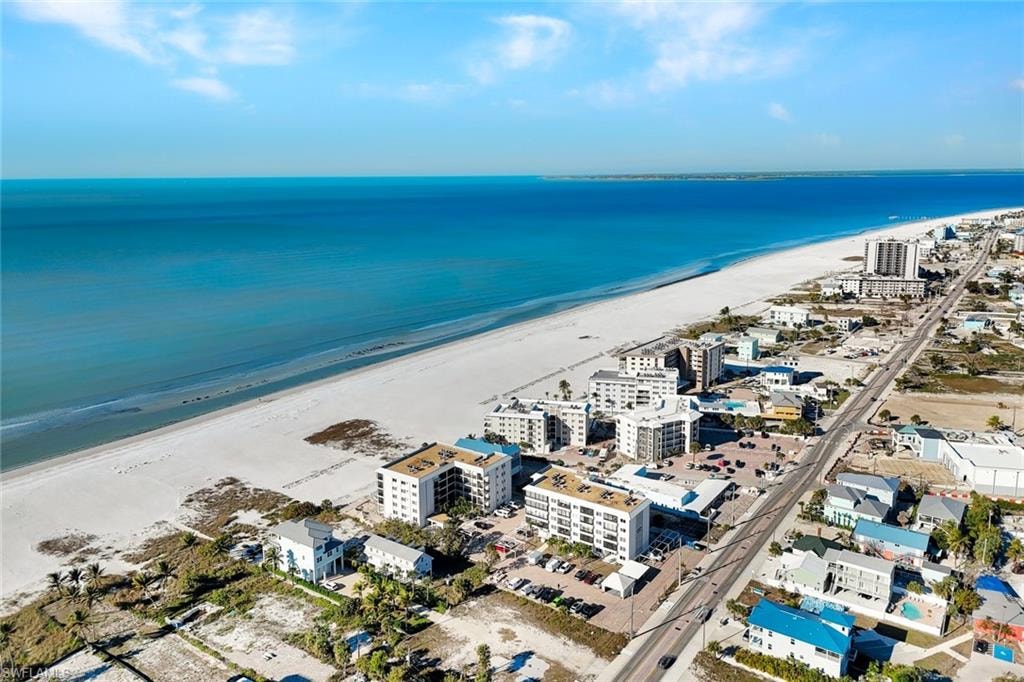 View of urban area with waterfront with a beach and apartment complex / building