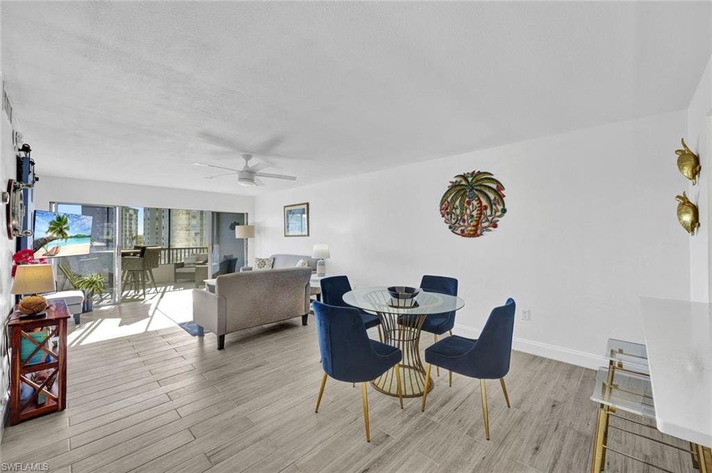 Dining area with light wood-type flooring and a ceiling fan