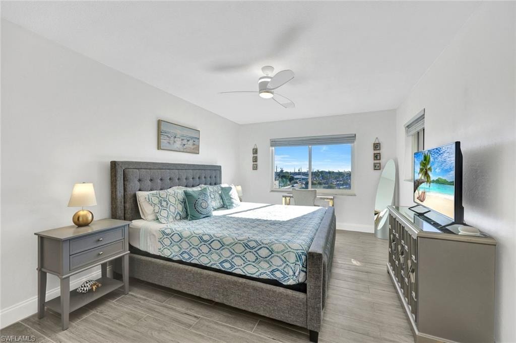 Bedroom with wood tiled floors and ceiling fan
