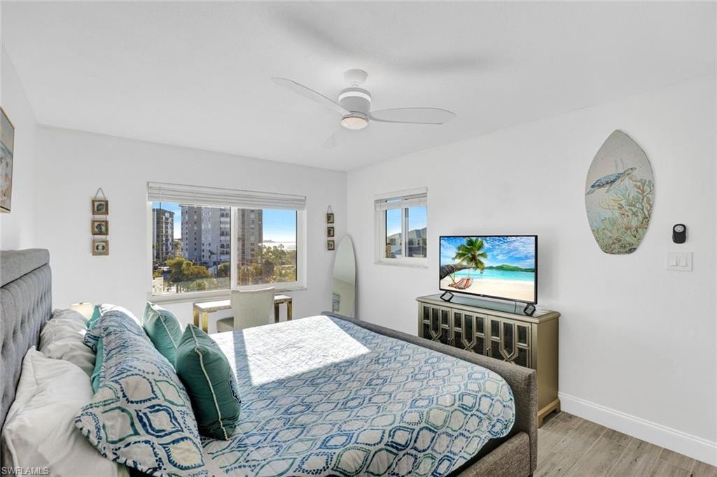 Bedroom with light wood-type flooring and a ceiling fan