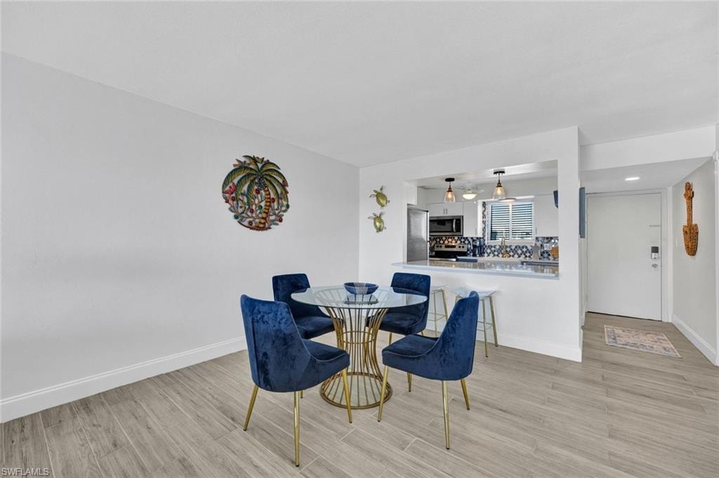 Dining space with light wood-style flooring
