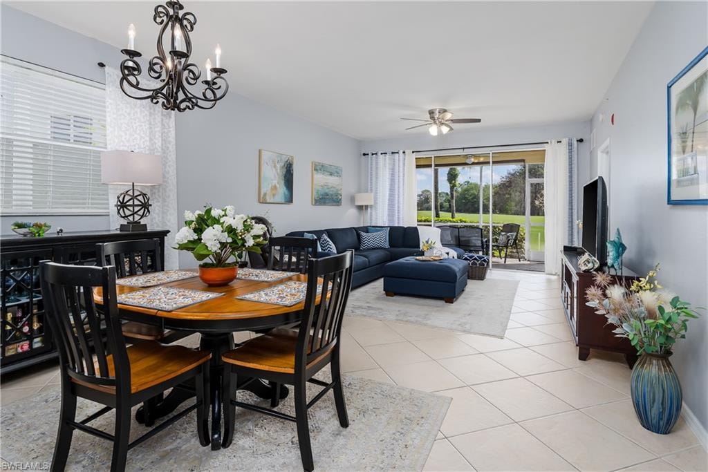 Dining area with healthy amount of natural light, ceiling fan, light tile patterned flooring, and hanging lights