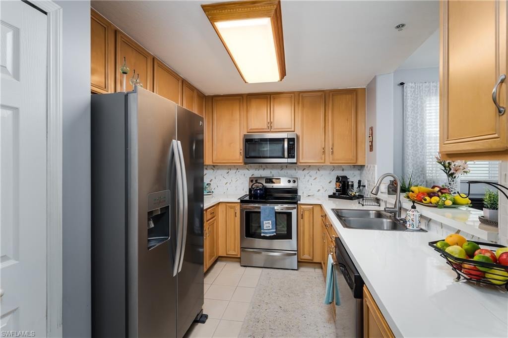 Kitchen with stainless steel appliances, tasteful backsplash, and wood finish cabinetry