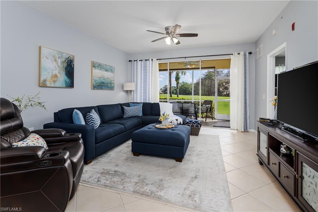 Living room with ceiling fan and light tile patterned floors