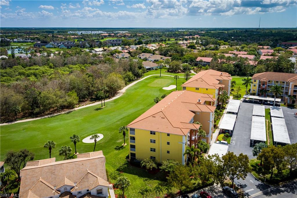 Aerial perspective of suburban area featuring a local golf course