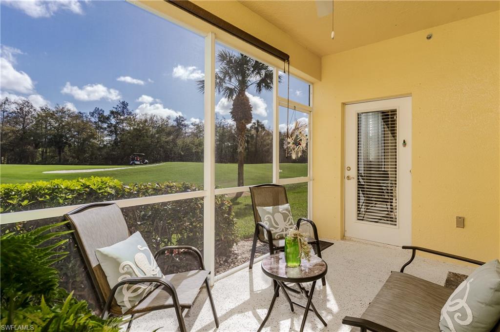 Sunroom featuring a ceiling fan and view of golf course