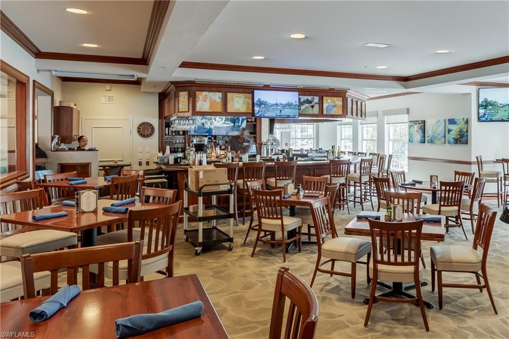 Dining space featuring crown molding, recessed lighting, beam ceiling, and stone finish flooring