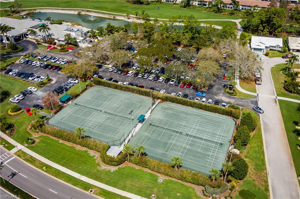 Drone / aerial view of a nearby body of water and a golf course