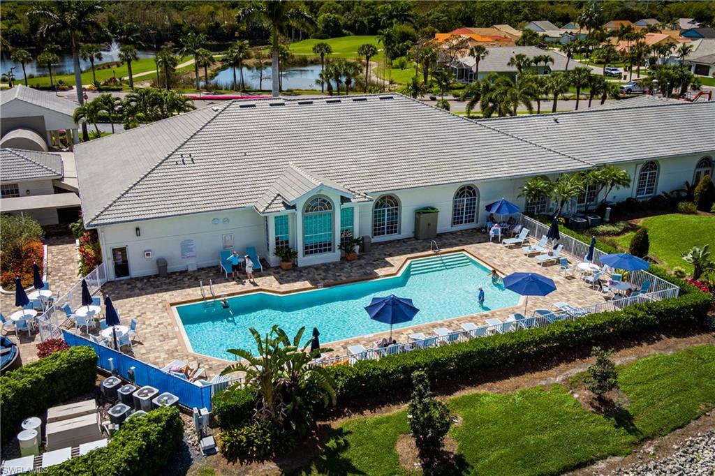 Community pool featuring a patio area and a water view
