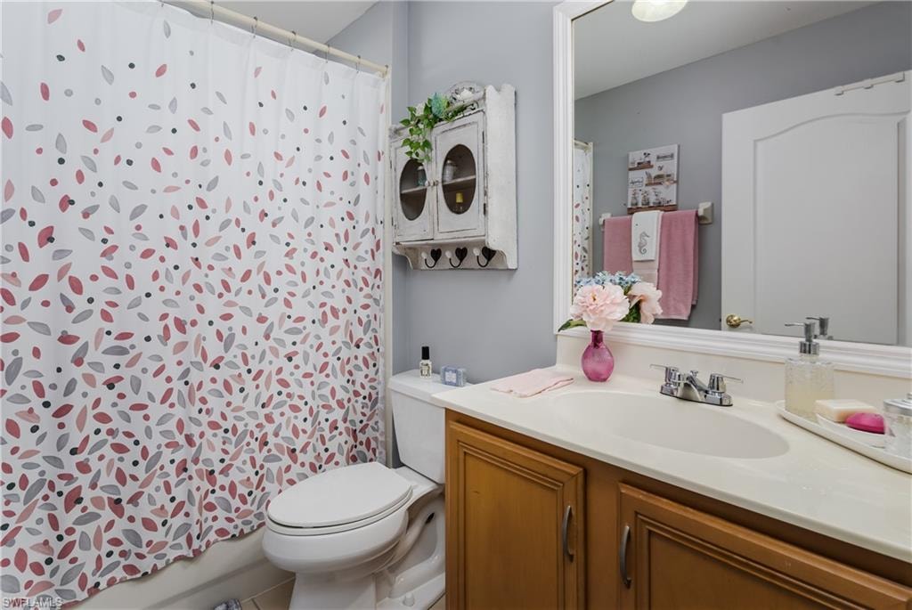 Full bath featuring vanity and toilet