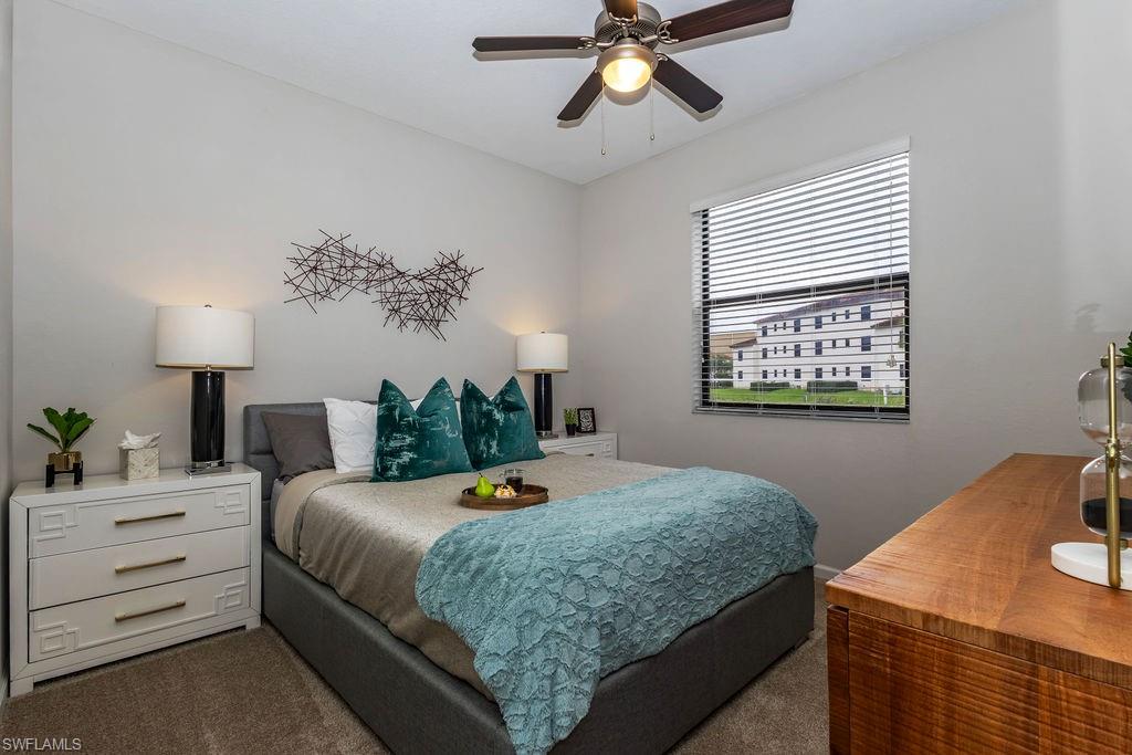 Carpeted bedroom with ceiling fan