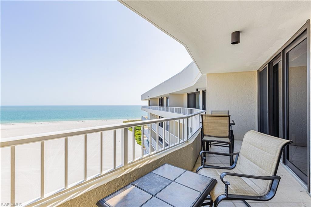 Balcony with a view of the beach and a water view