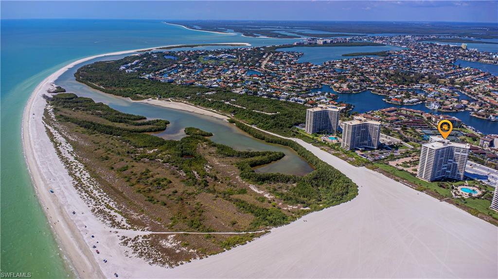 Aerial view featuring a water view and a beach view