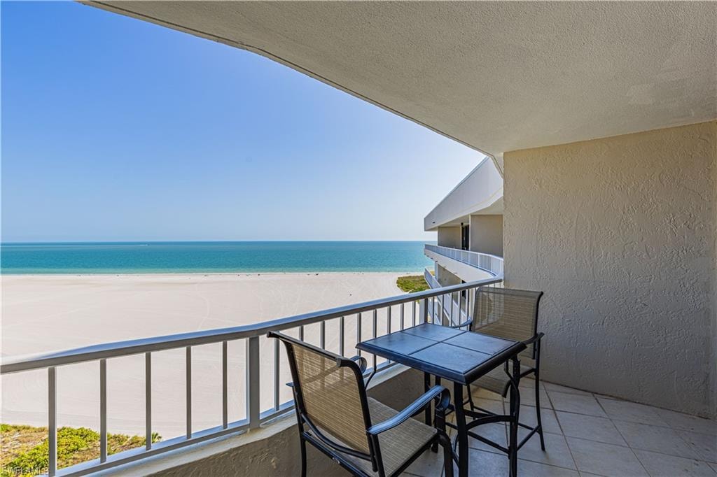Balcony with a water view and a beach view