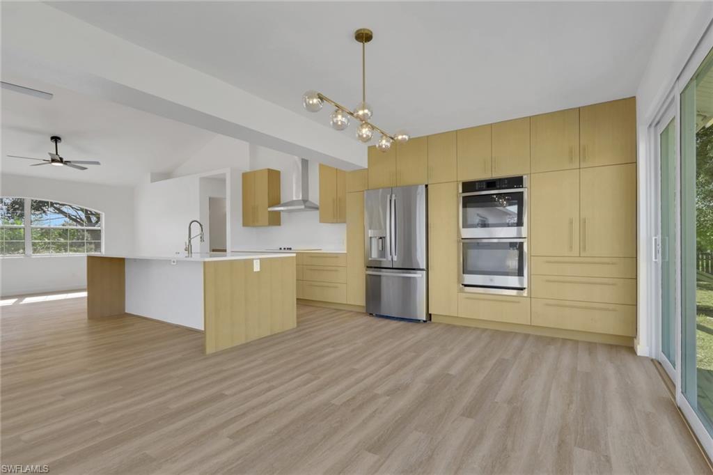 Kitchen featuring plenty of natural light, modern cabinets, stainless steel appliances, and a ceiling fan