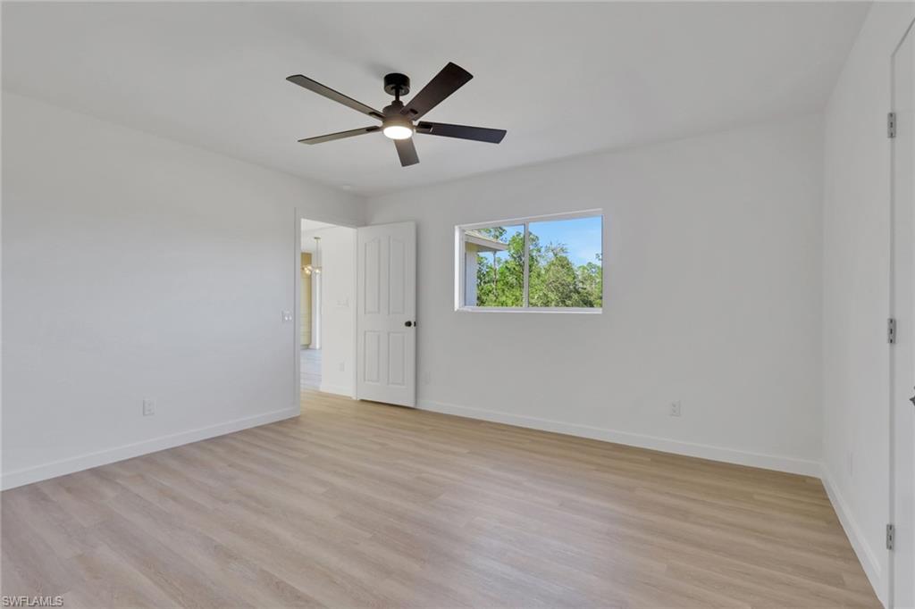 Unfurnished room with light wood-style flooring and ceiling fan