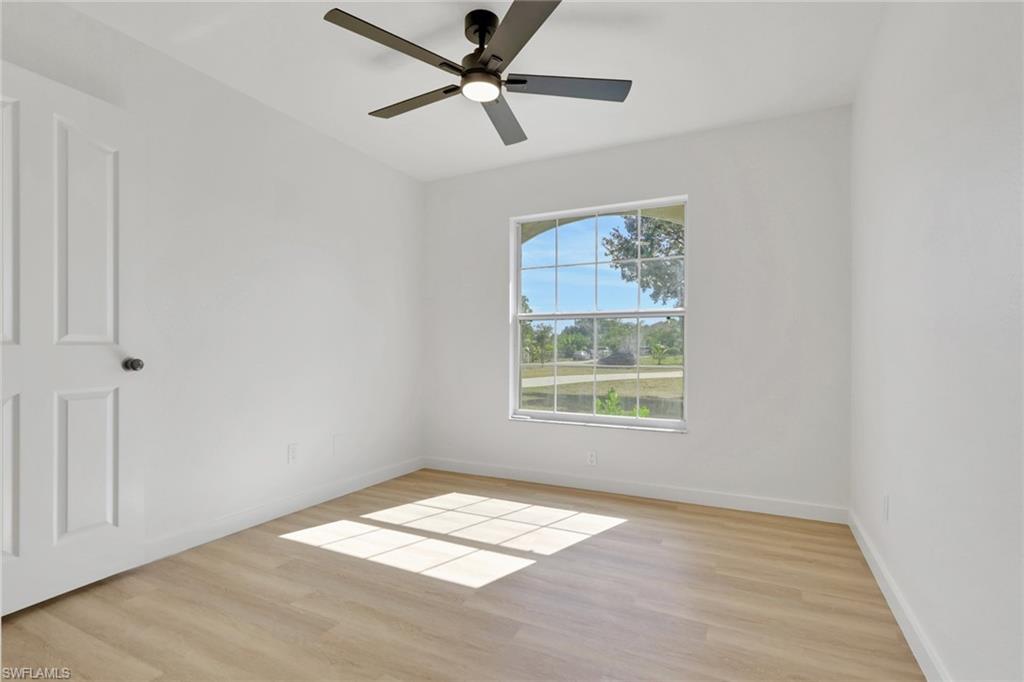 Unfurnished room with light wood-style flooring and a ceiling fan
