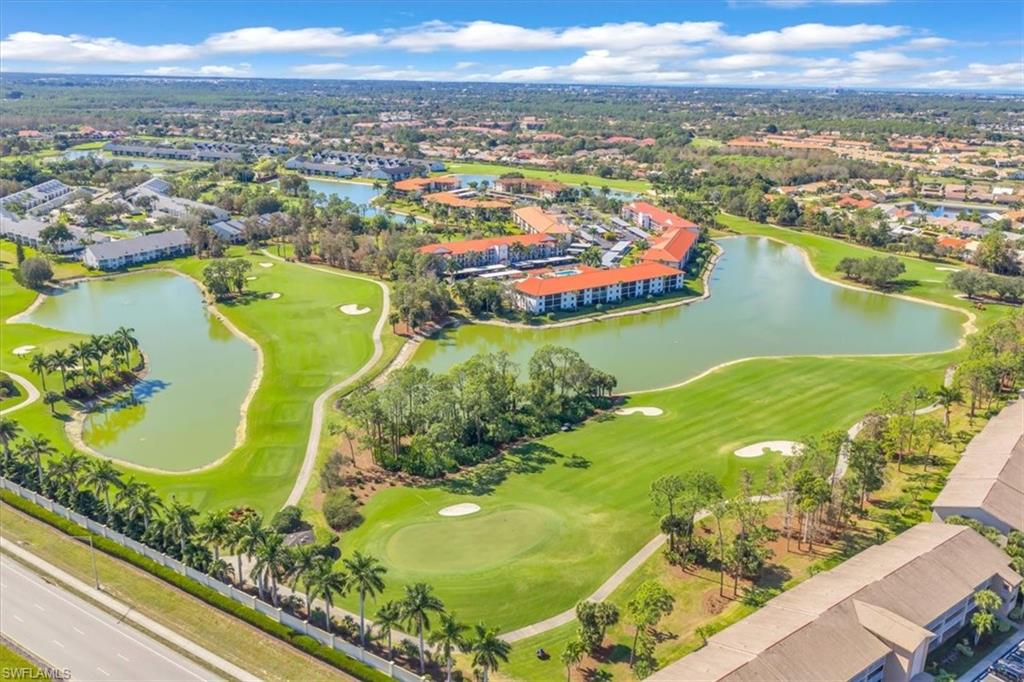 Drone / aerial view of a local golf course and a nearby body of water