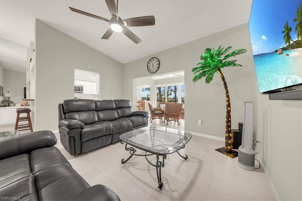 Living area featuring vaulted ceiling and ceiling fan