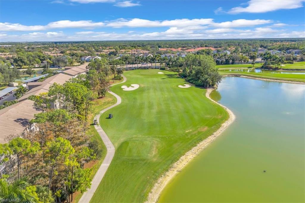 Aerial perspective of suburban area with a large body of water and a golf club
