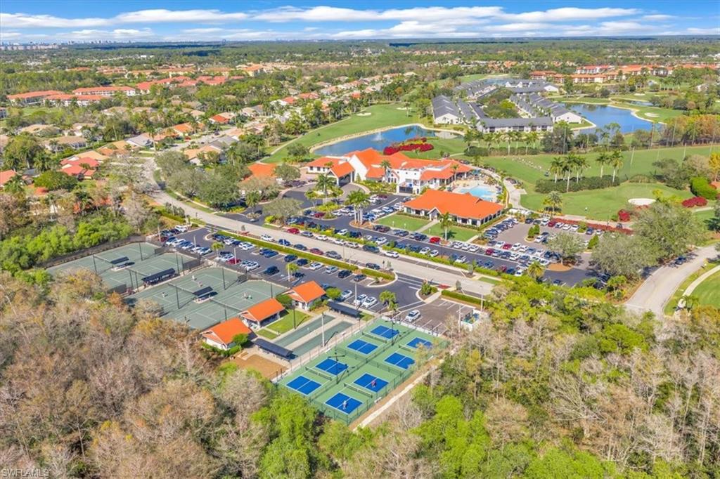 Aerial view of residential area with a large body of water and a golf course