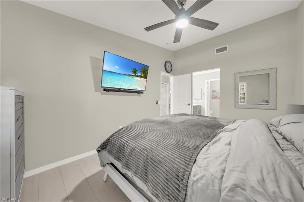 Bedroom featuring a ceiling fan and connected bathroom
