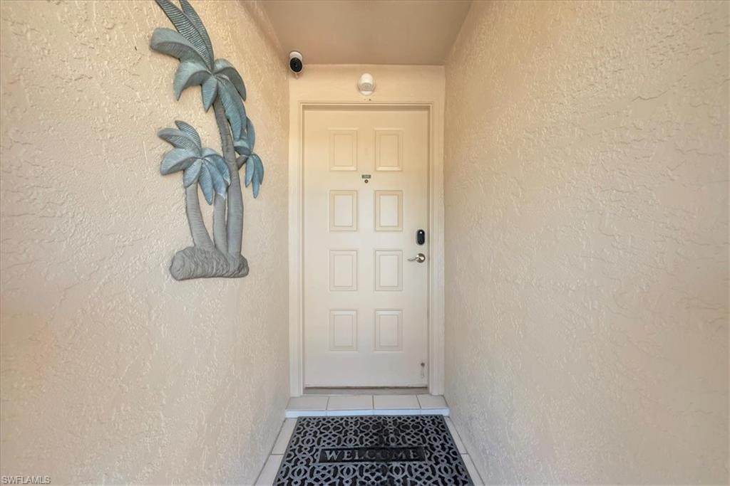 Property entrance with stucco siding