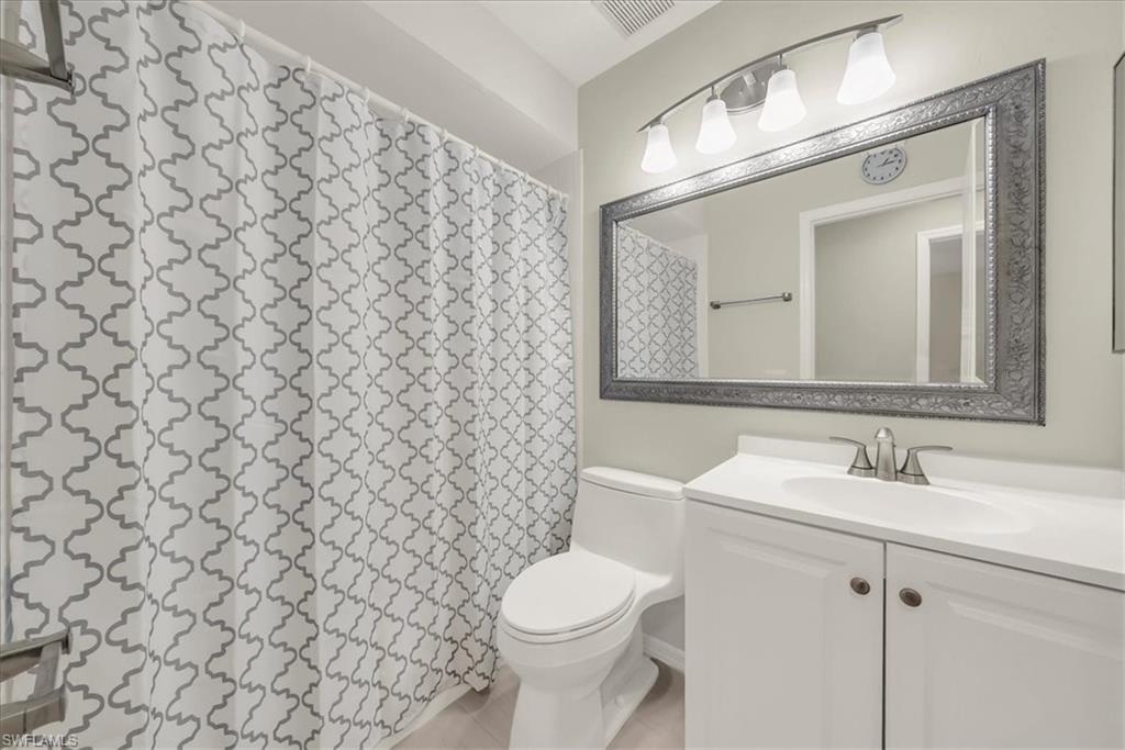Bathroom featuring vanity and a shower with shower curtain