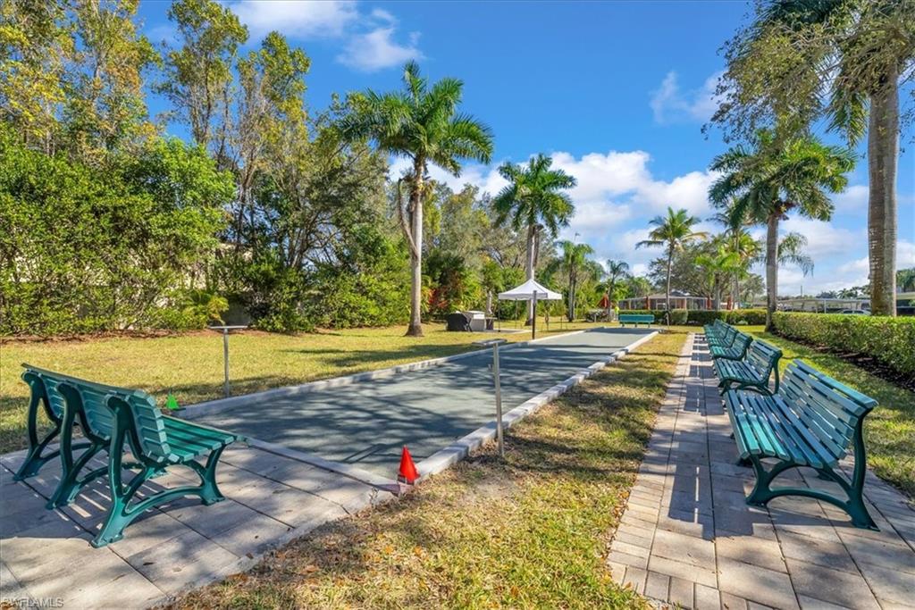 View of home's community with a yard and a game area