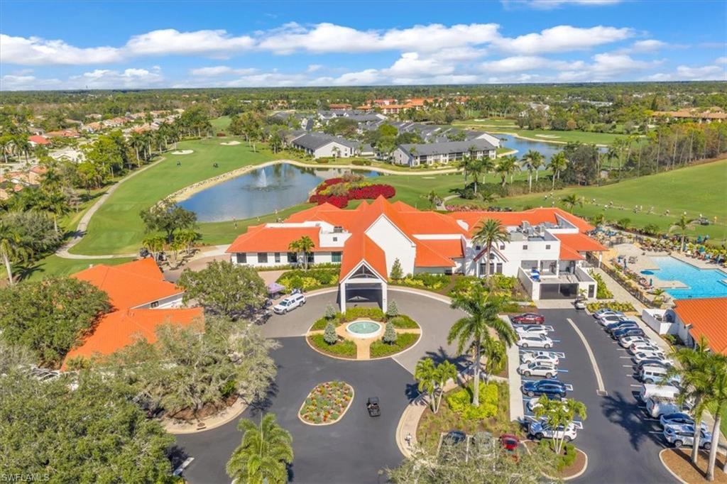 Drone / aerial view of a nearby body of water and a golf course