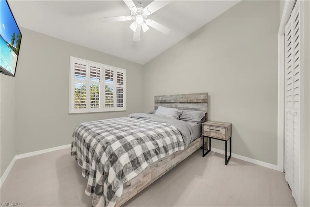 Bedroom with vaulted ceiling and a ceiling fan