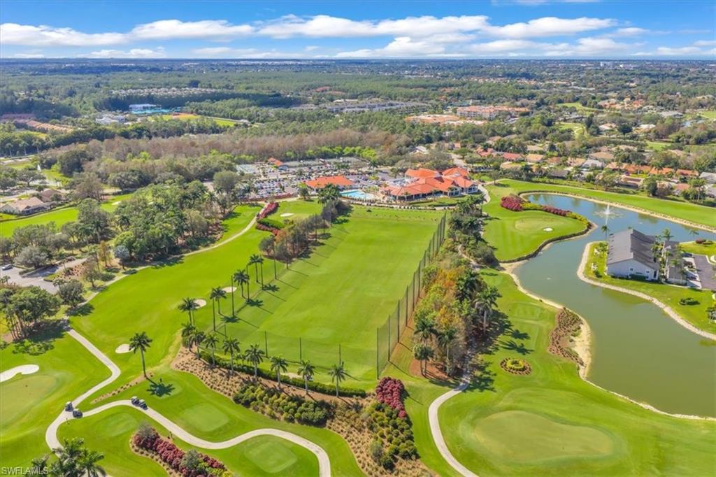 Aerial perspective of suburban area featuring a large body of water and a golf club
