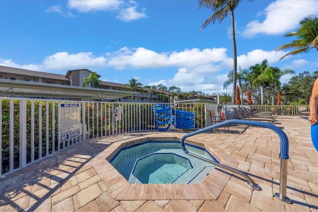 View of swimming pool featuring a pool, a hot tub, and a patio