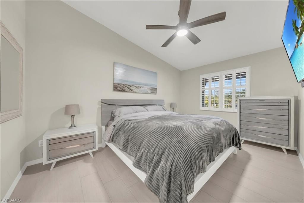 Bedroom with vaulted ceiling and a ceiling fan