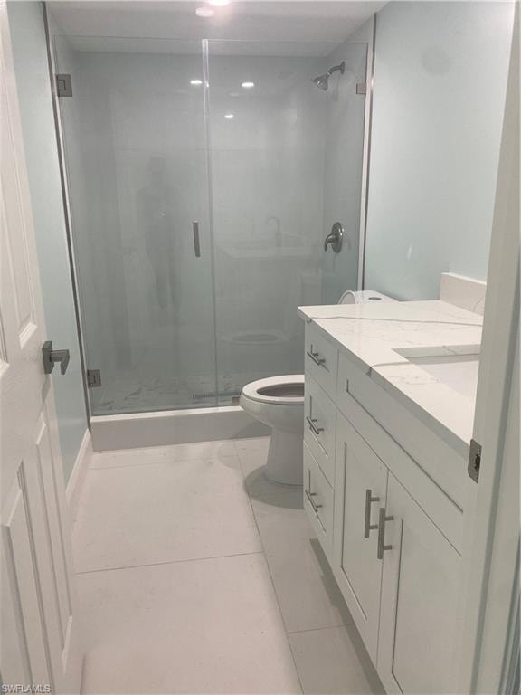 Bathroom featuring vanity, a stall shower, and light tile patterned floors