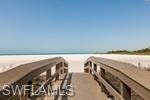 Surrounding community featuring a water view and a view of the beach