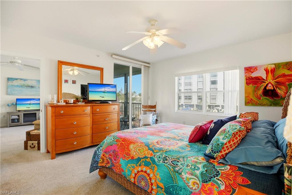 The primary bedroom enjoys an en-suite bath, walk-in closet and slider out to the screened lanai.