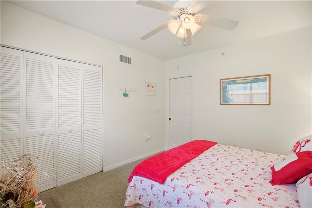 The carpeted bedroom offers plenty of closet space.