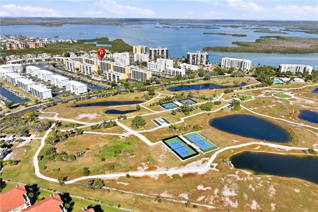 Amenities include walking paths with park benches, a beach access path, tiki huts with picnic tables, tennis courts, pickleball courts, bocce courts, putting green, pitching green, driving cage, fishing pier, and more.