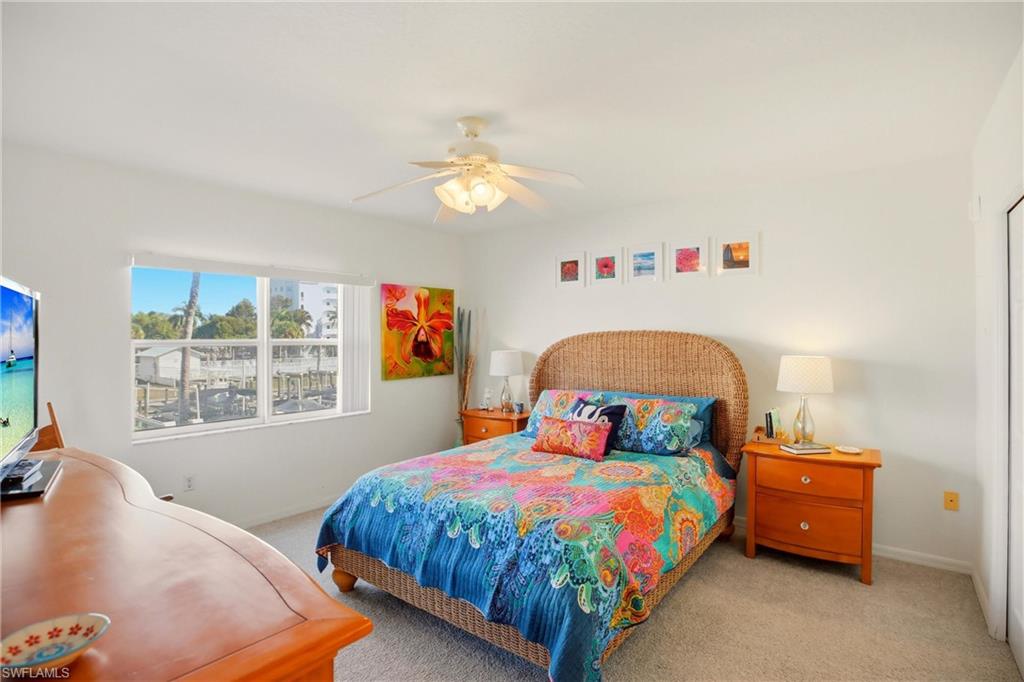 The primary bedroom enjoys an en-suite bath, walk-in closet and slider out to the screened lanai.
